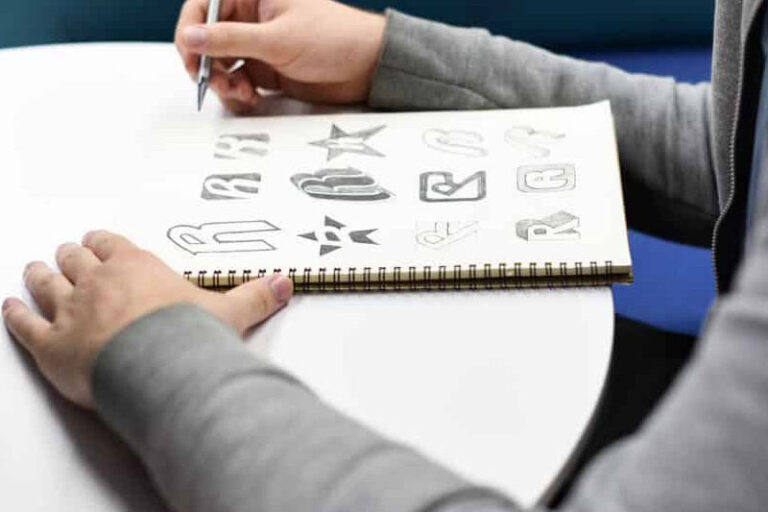 An artist drawing different brand logos