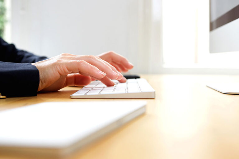 Female hands typing on computer keyboard