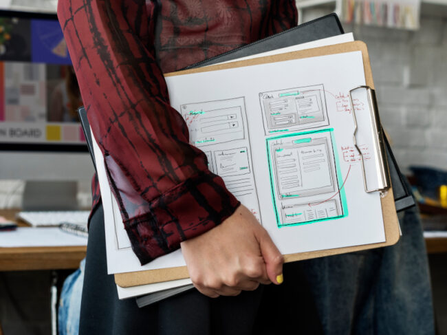 Man carrying a clipboard used to create a website. Clipboard used to create a website
