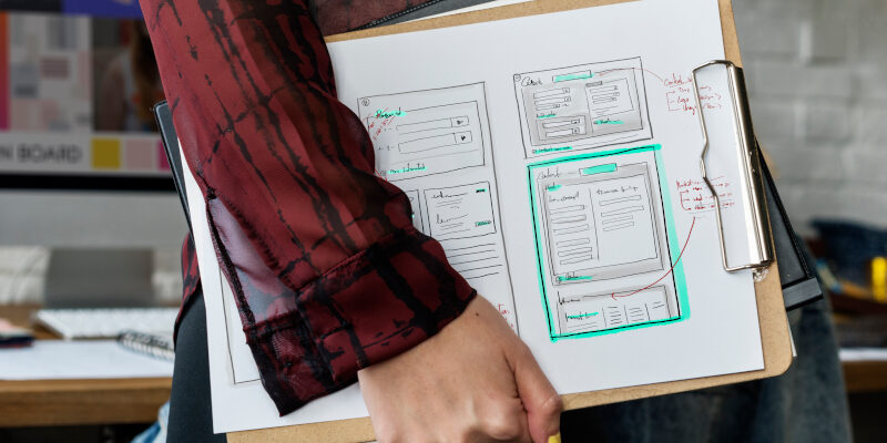 Man carrying a clipboard used to create a website. Clipboard used to create a website