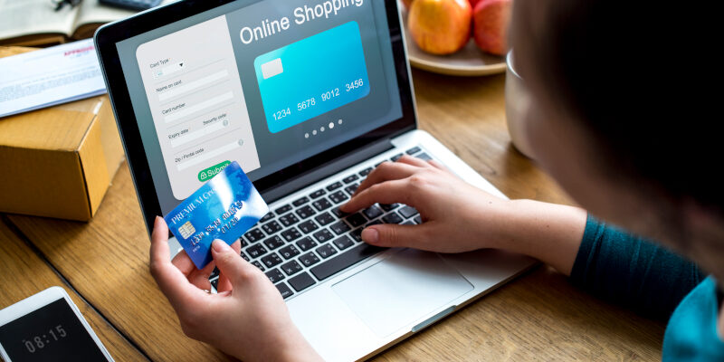 An online shopper enters their card into an ecommerce web design. An online shopper enters their card into an ecommerce web design.