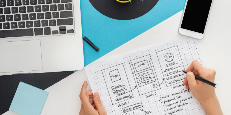 Hands drawing out a Kalamazoo web design