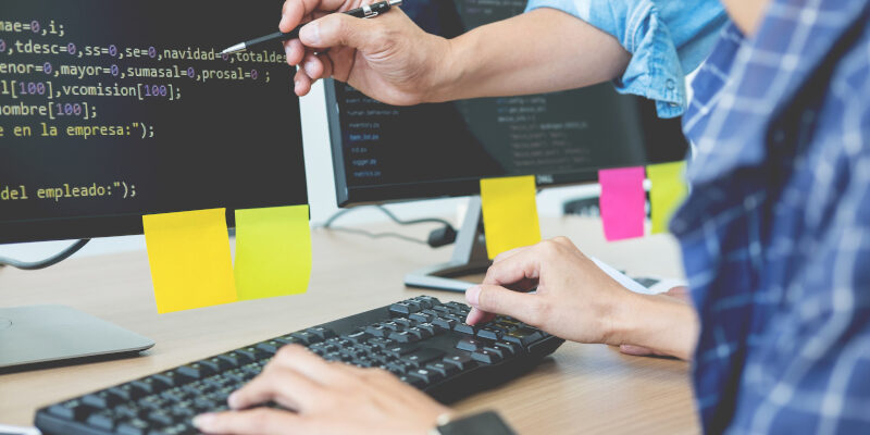 A team discussing a Kalamazoo website design by a computer.