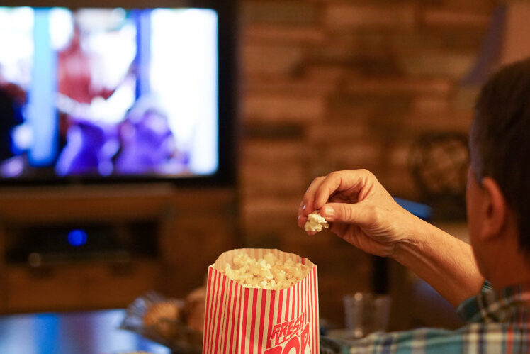 Man watching a movie for web design inspiration.