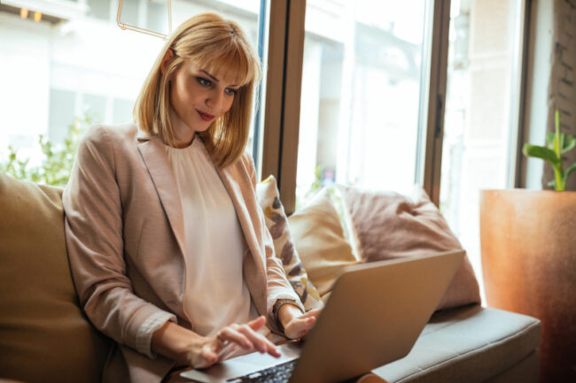 A woman sitting on her couch blogging A woman sitting on her couch blogging