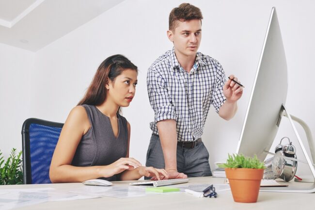 Designers discussing website interface Web developers discussing ADA compliance for web design