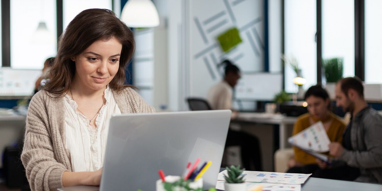 Close up of satisfied businesswoman answering email Woman working on an email marketing campaign in an office setting.