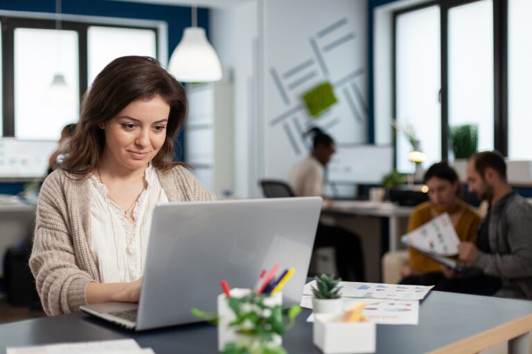 Woman working on an email marketing campaign in an office setting.